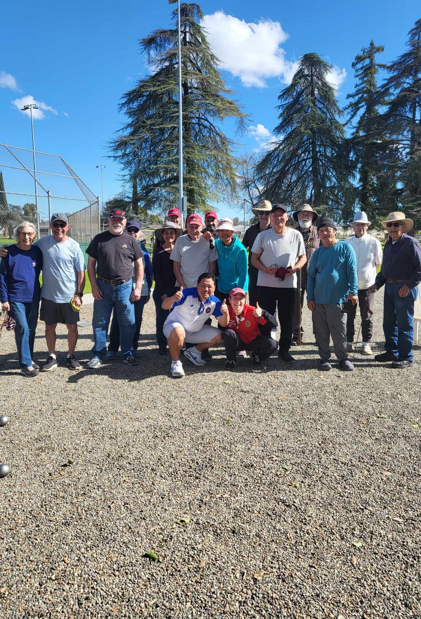 A large and diverse group of Fresno pétanque players